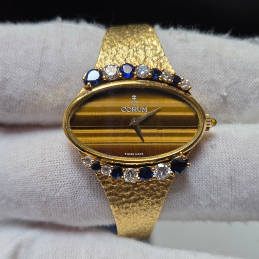 Corum vintage 18k gold watch with tiger's eye dial and diamonds and sapphires